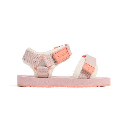 Pink and white sandal with a visible brand logo on a white background