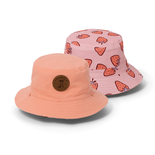 Two bucket hats, one peach and one pink with strawberry pattern, on a white background.