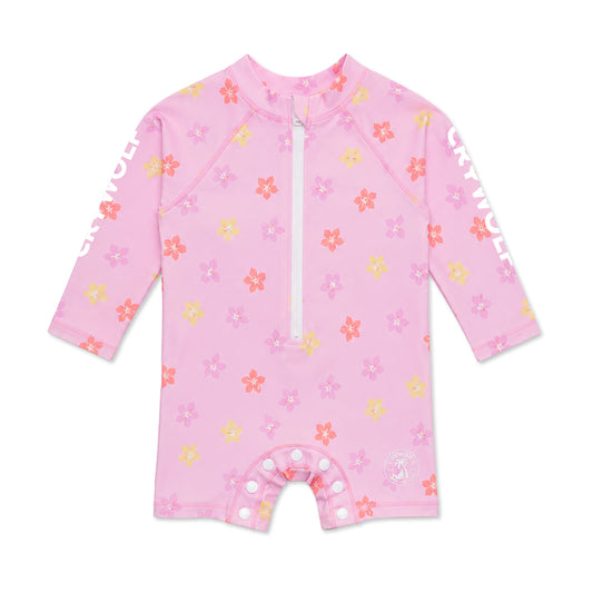 A pink long-sleeve baby sun shirt with a white zipper at the neck, featuring a colorful floral pattern in pink, orange, and yellow. The brand name 'GARTWICK' is printed in white on both sleeves, and the bottom has snap closures.