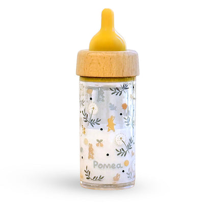 Baby bottle with floral design and wooden cap on a white background
