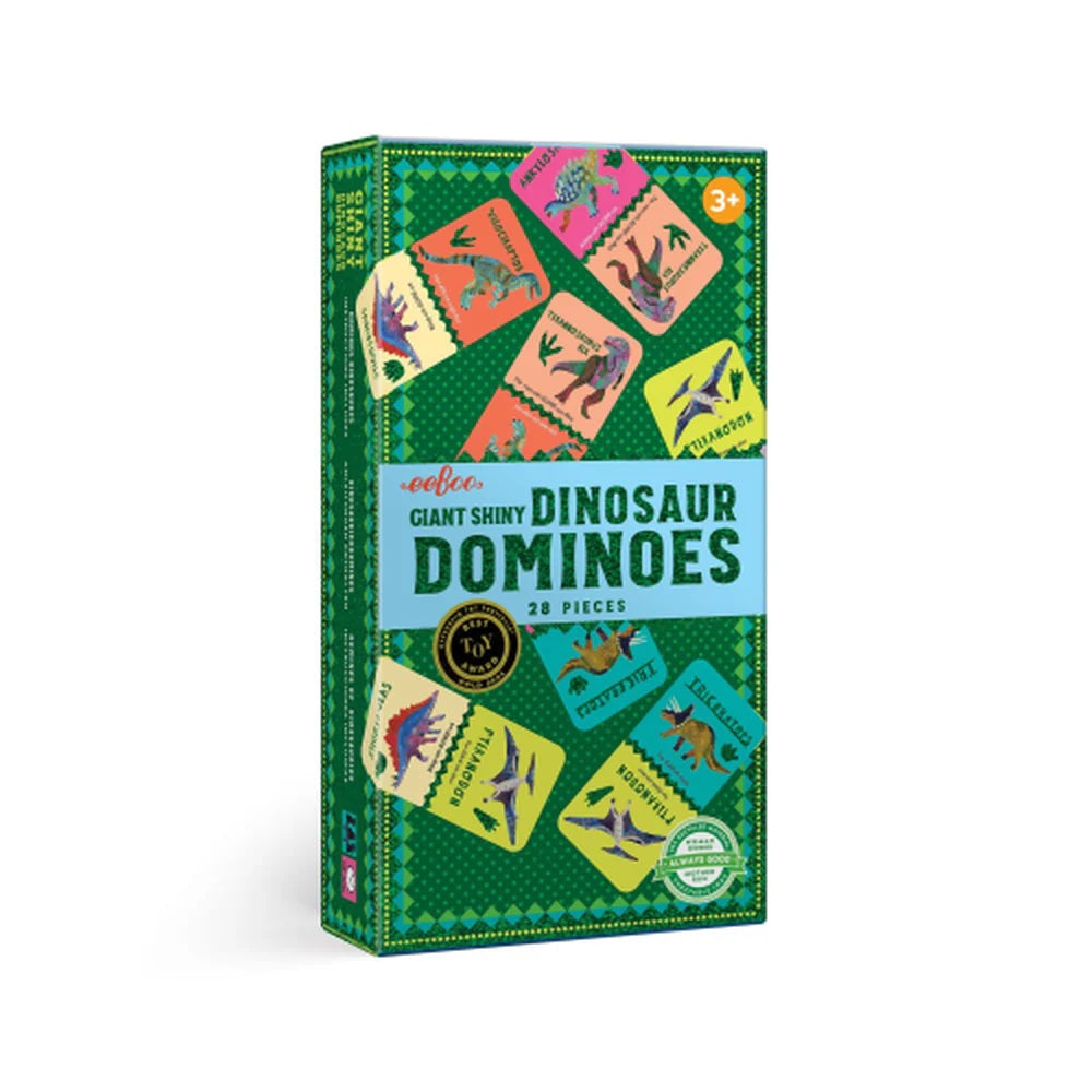 Box of giant shiny dinosaur dominoes with colorful dinosaur illustrations on a green background