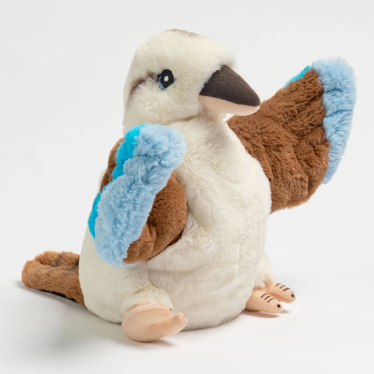 Plush toy penguin with blue feet on a white background