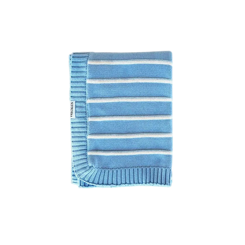 Folded blue and white striped blanket on a light beige background