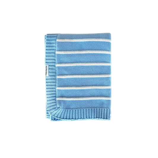 Folded blue and white striped blanket on a light beige background