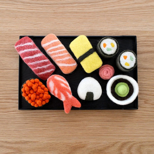 Sushi-themed dog toys on a wooden surface