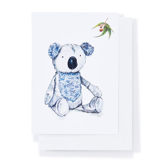 Stuffed koala toy with floral details on a white background