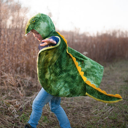Person wearing a green dinosaur costume in a field