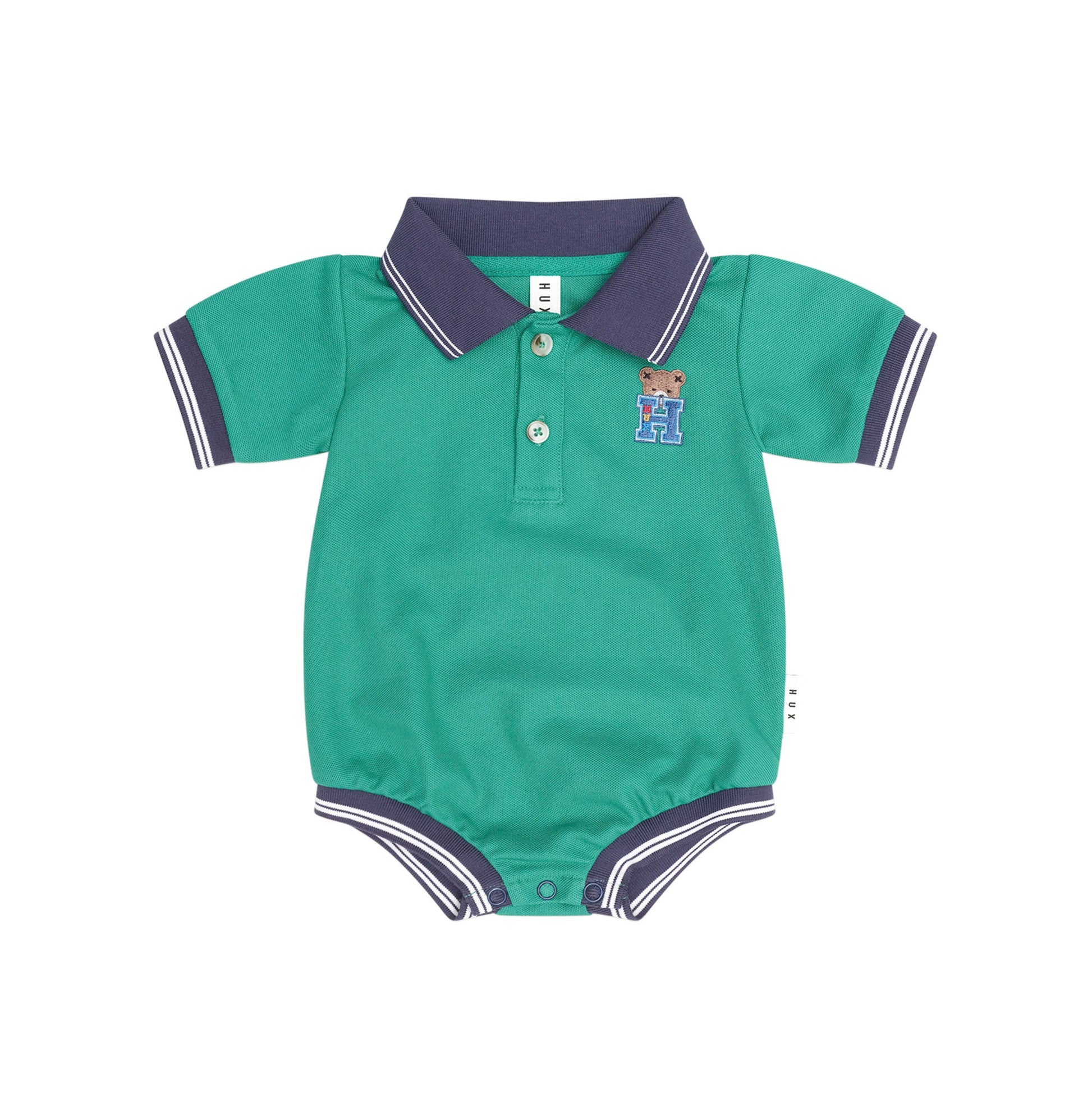 A baby short-sleeve polo romper in teal green with a dark purple collar and sleeve trim, featuring a three-button placket and a small embroidered teddy bear logo on the chest.