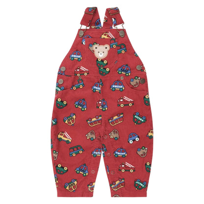 Red children's overalls with vehicle pattern on a beige background