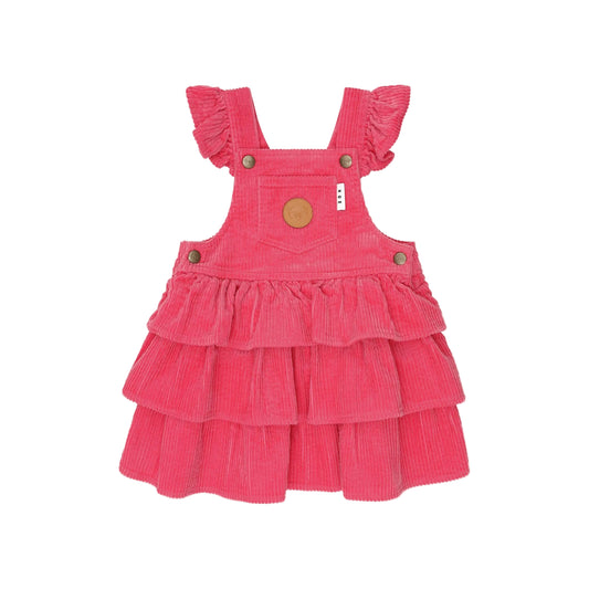 Pink corduroy dress with ruffled layers on a white background