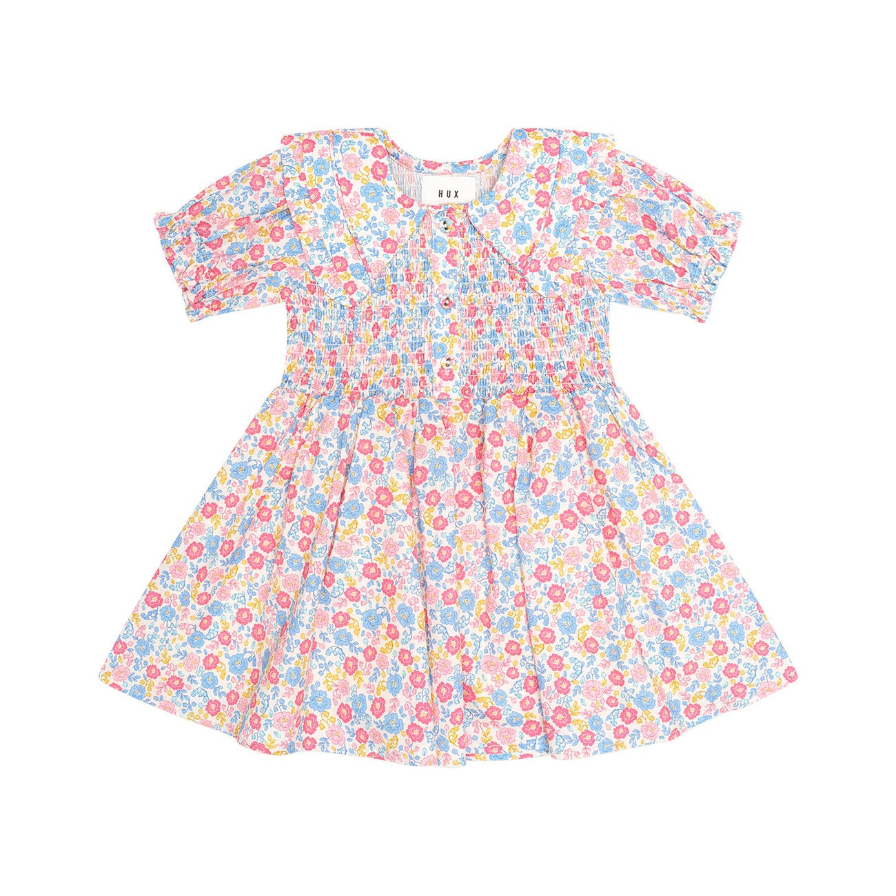 A short-sleeve baby dress with a colorful floral print on a white background, featuring puff sleeves and a smocked bodice.