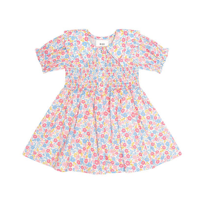 A short-sleeve baby dress with a colorful floral print on a white background, featuring puff sleeves and a smocked bodice.