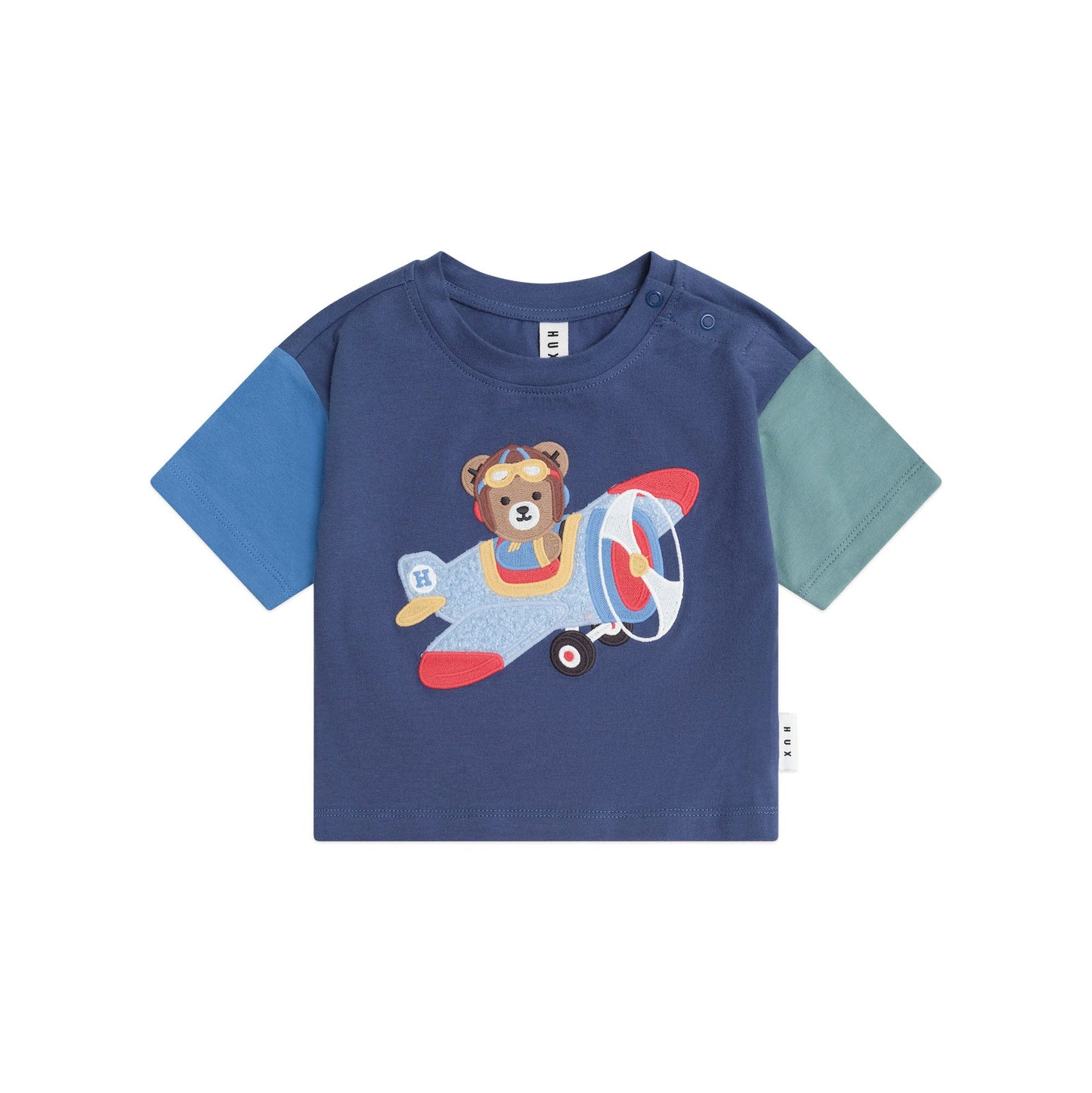 Children's t-shirt with a bear on an airplane design on a white background