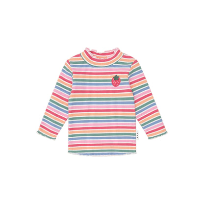 Multicolored striped shirt with a small apple design on a light pink background