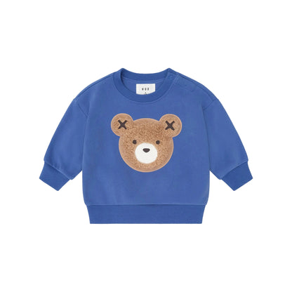 Blue children's sweatshirt with a bear face design on a beige background