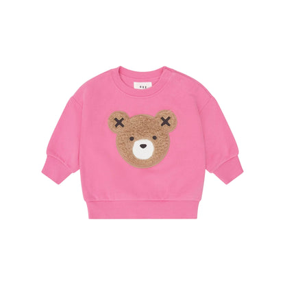 Pink sweatshirt with a bear face design on a light pink background