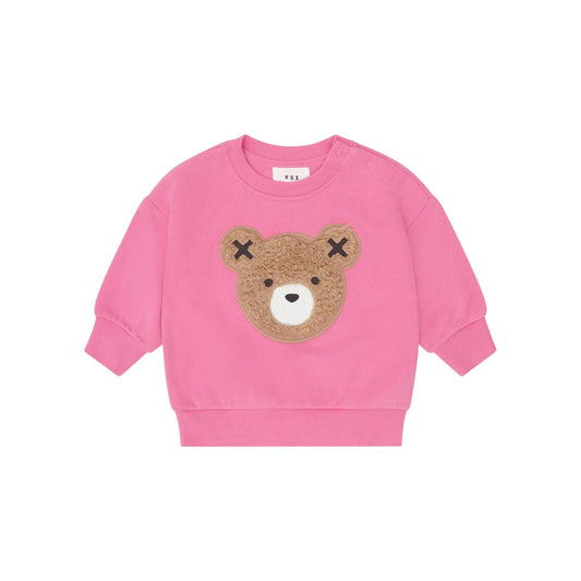 Pink sweatshirt with a bear face design on a light pink background