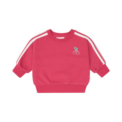 Pink sweatshirt with white stripes on sleeves against a light pink background