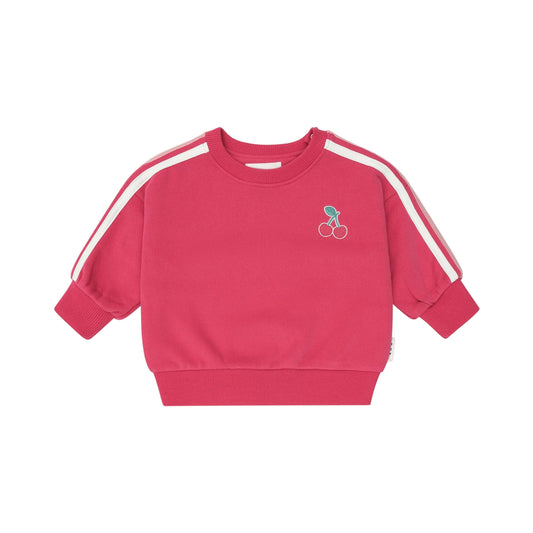 Pink sweatshirt with white stripes on sleeves against a light pink background