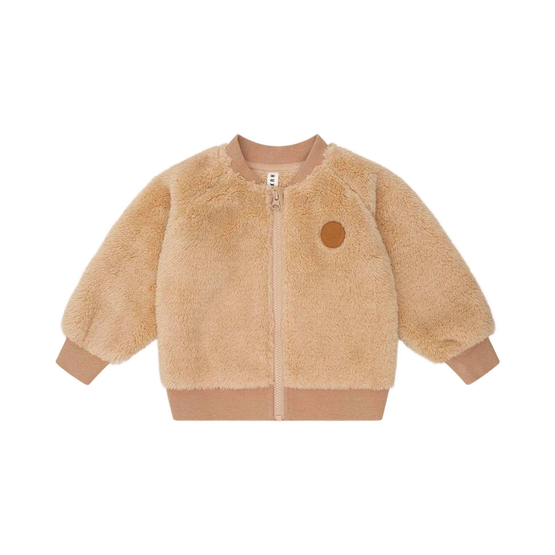 Beige teddy jacket with a brown patch on a beige background