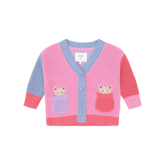 Pink and blue cardigan with cat designs on a light pink background