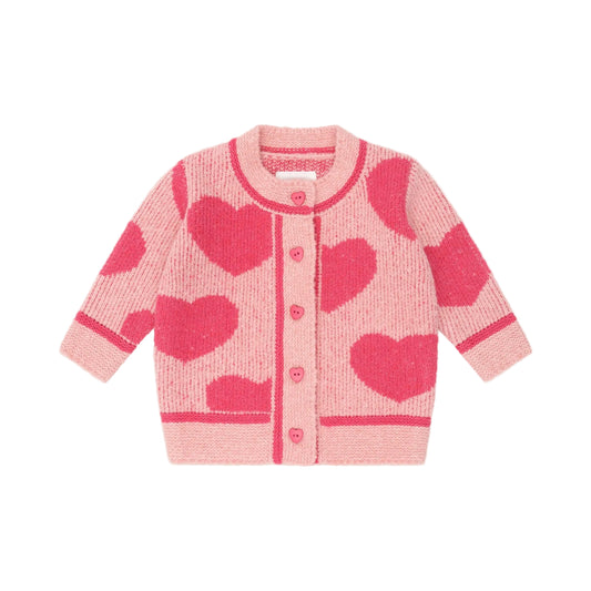 Pink cardigan with heart patterns on a light pink background