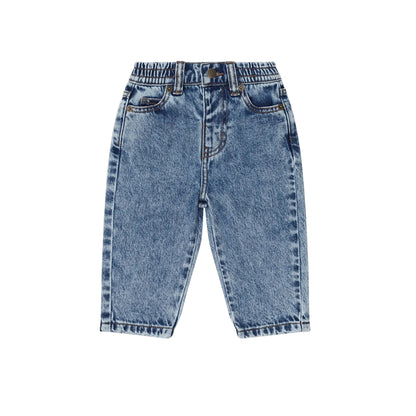 Pair of blue jeans on a beige background