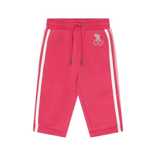 Pink sweatpants with white stripes on a light pink background