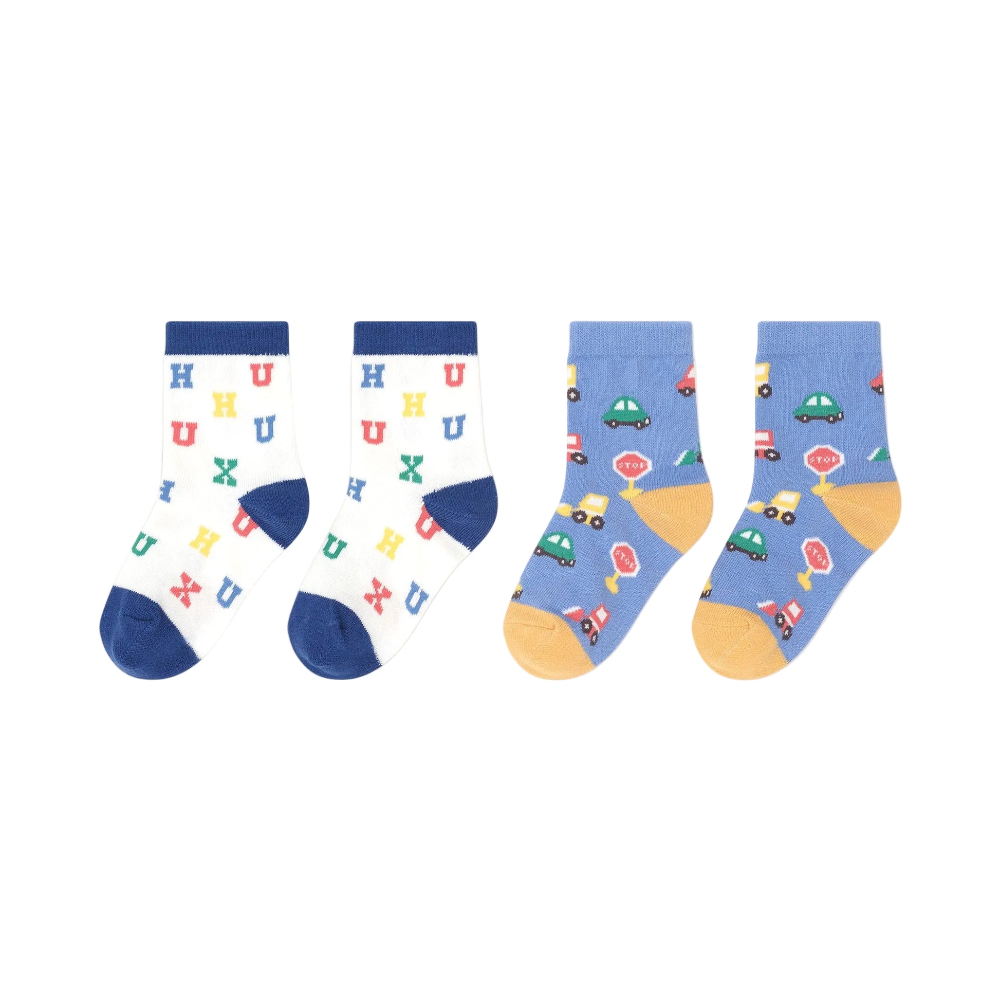 Two pairs of children's socks with colorful patterns on a beige background