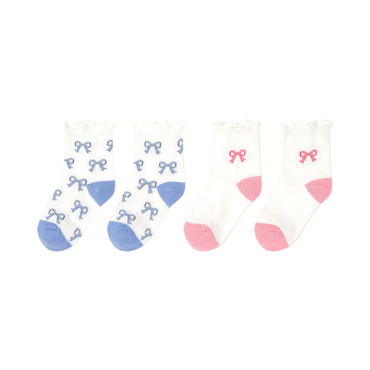 Set of three children's socks with bow patterns on a beige background