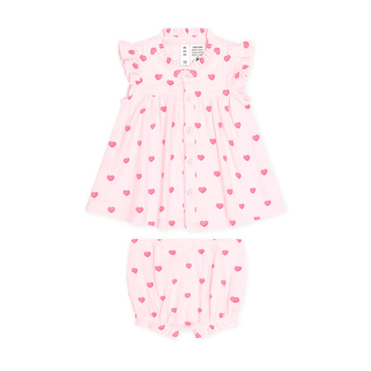A two-piece baby outfit set consisting of a light pink dress with ruffle sleeves and a matching pair of bubble shorts, both decorated with a small pink heart pattern, shown on a plain white background.