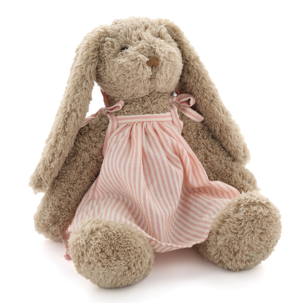 Stuffed bunny toy wearing a pink striped dress on a white background