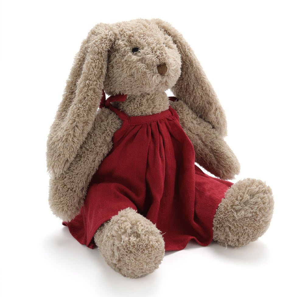 Stuffed bunny toy with a red dress on a white background