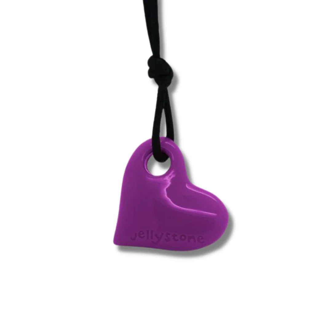 Purple heart-shaped jellystone on a black cord against a white background