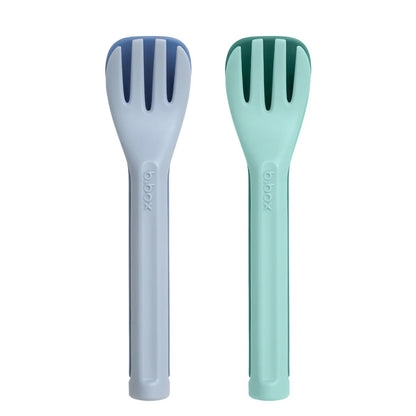 Two salad servers, one blue and one green, on a white background