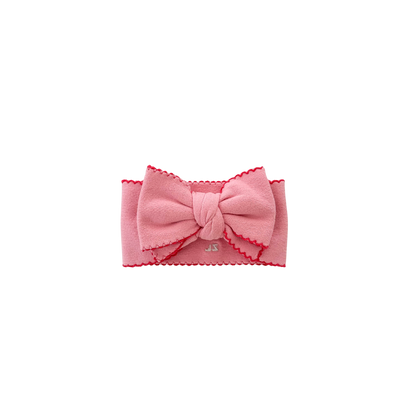Pink headband with a bow on a white background
