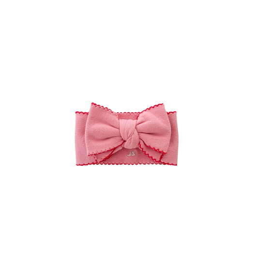 Pink headband with a bow on a white background