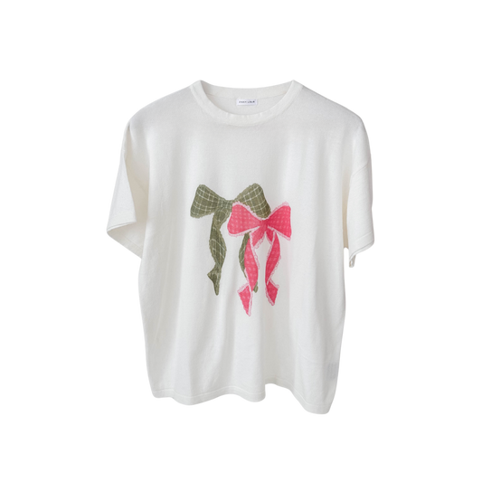 White t-shirt with decorative bows on a white background