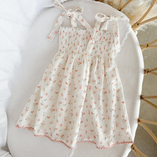 Floral dress on a chair with a neutral background