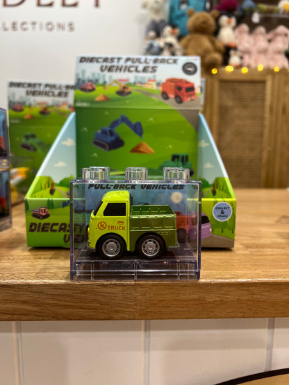 Toy truck packaging on a wooden surface with a blurred background