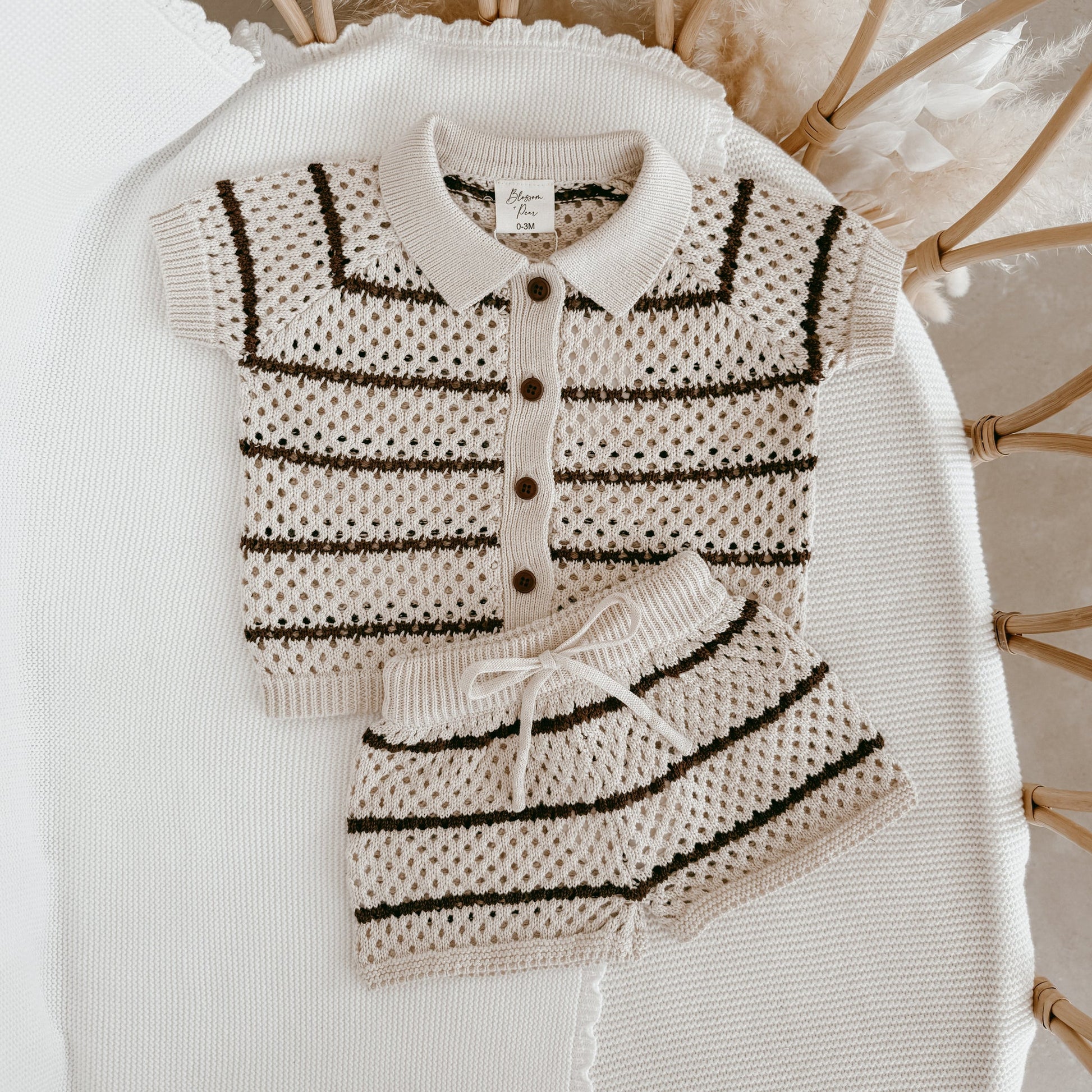 Knitted outfit with cardigan and skirt on a white surface