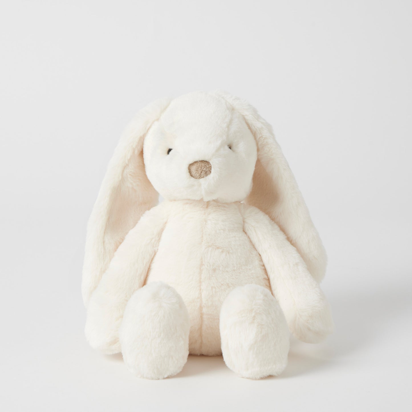 White plush bunny toy on a light gray background