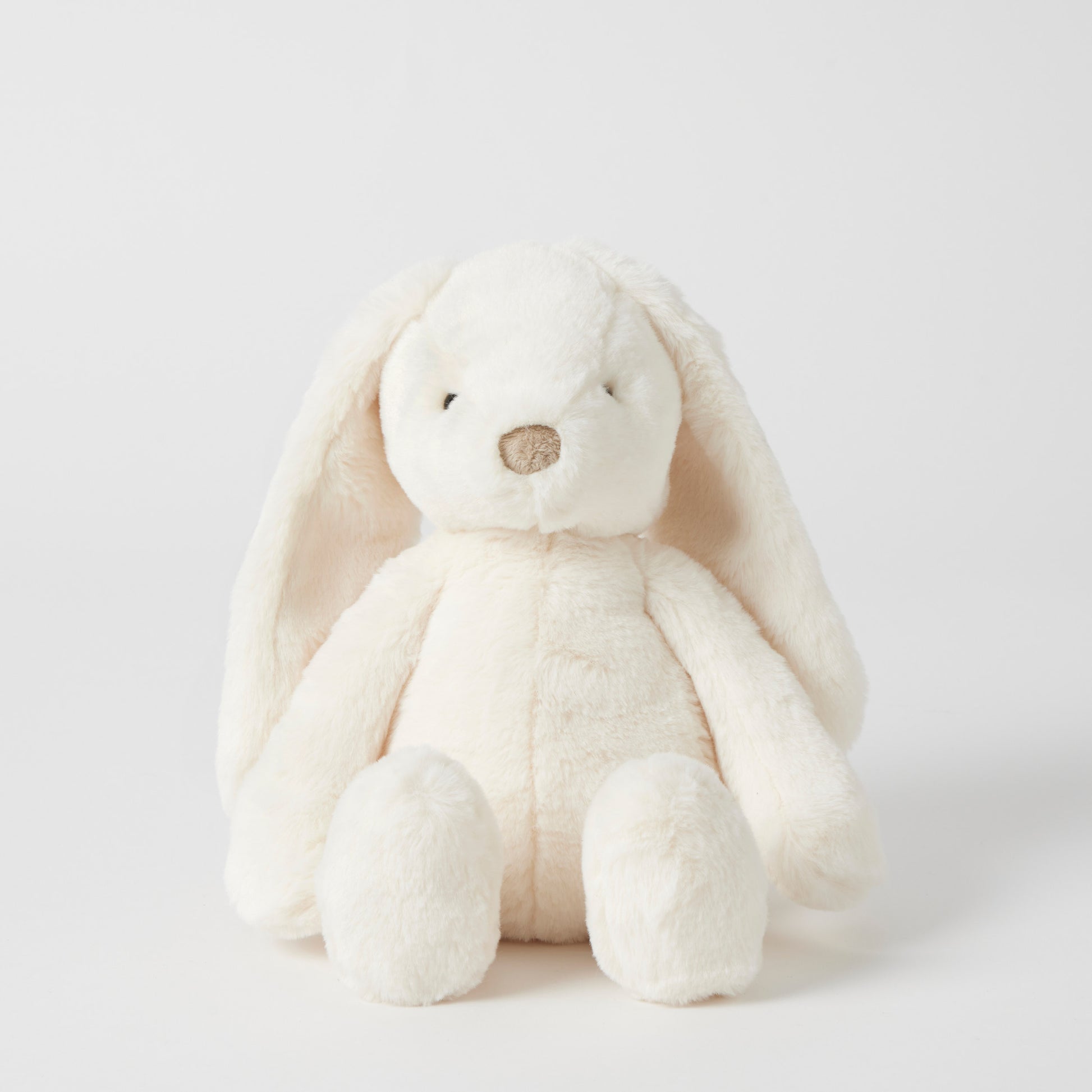 White plush bunny toy on a light gray background