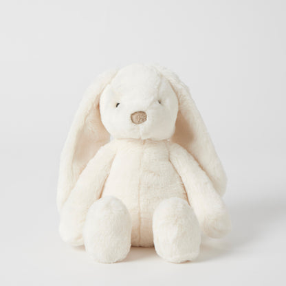 White plush bunny toy on a light gray background