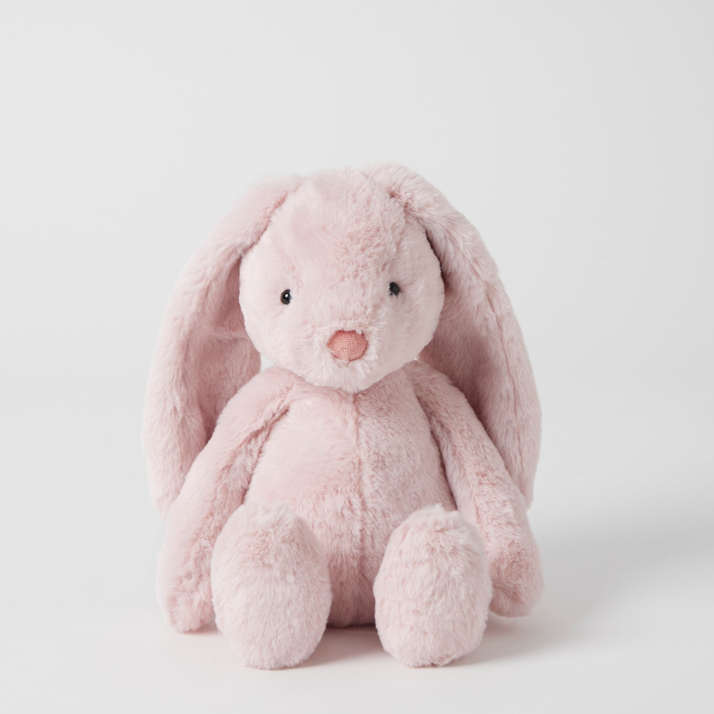 Pink plush bunny toy on a white background