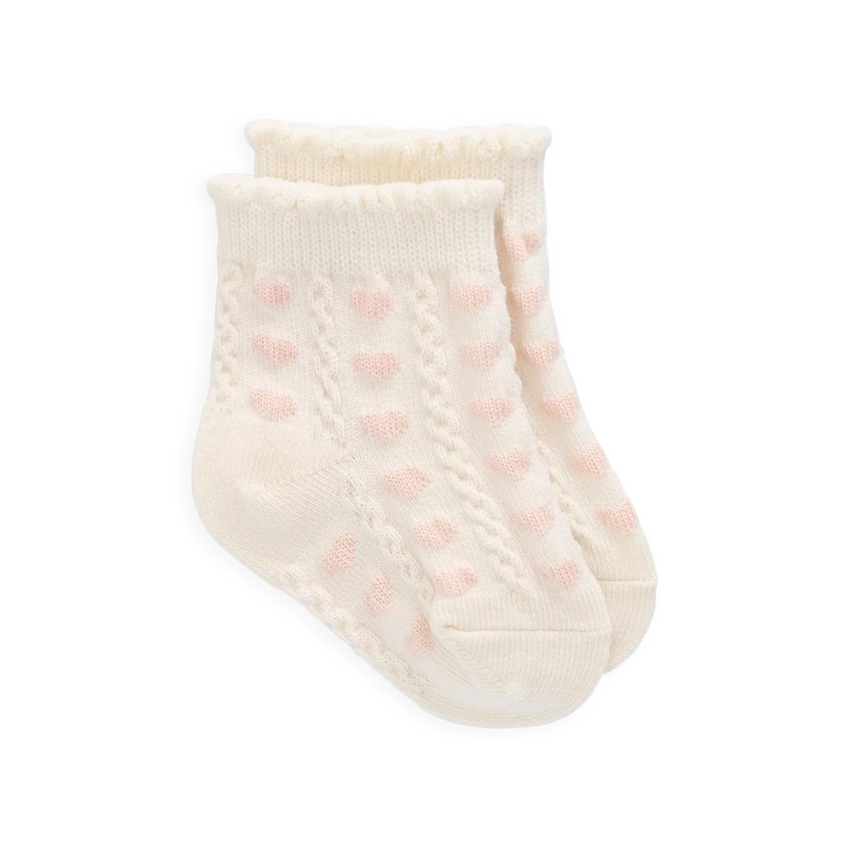 Cream-colored baby sock with pink polka dots on a white background