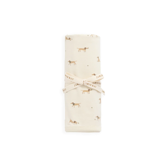 Folded fabric with small dog pattern on a white background