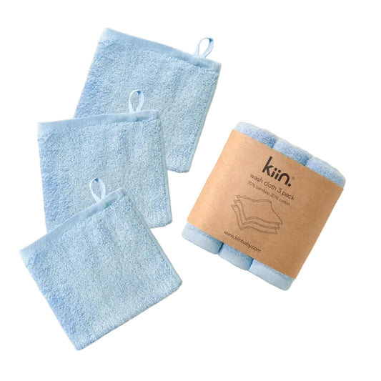 Set of blue towels with a brown kiai co branded paper bag on a beige background