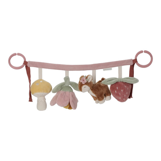 Baby crib mobile with plush toys including a mushroom, flower, and animal on a pink bar.