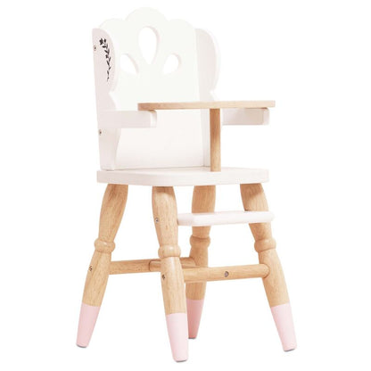 Wooden high chair with pink accents on a white background